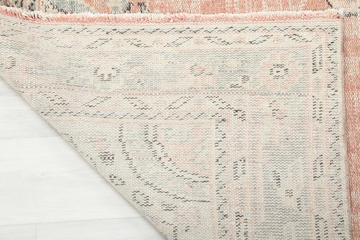 View of the back of the hand-knotted rug, revealing the intricate weaving