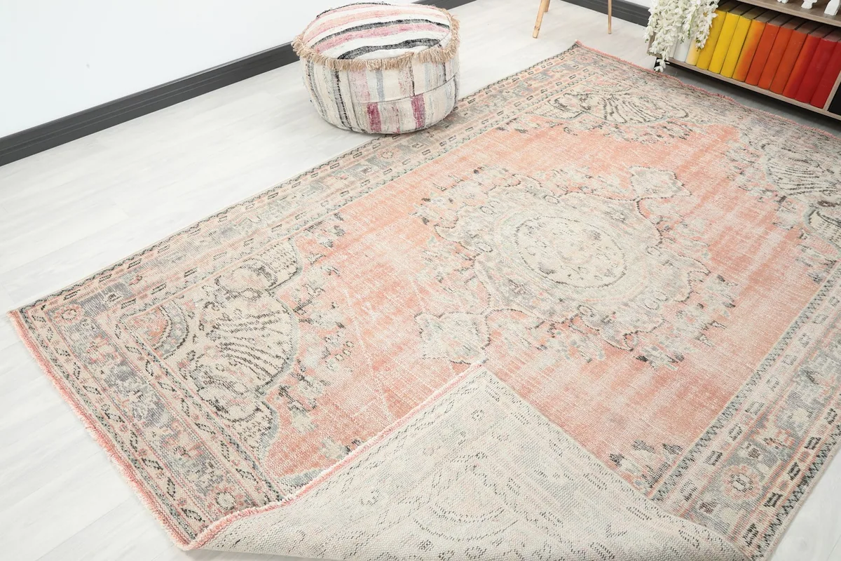 Corner of the rug folded back, showing the back of the rug and its construction