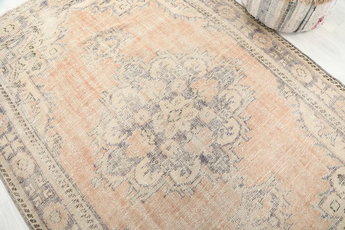 Close-up detail of the central medallion design and surrounding rust field