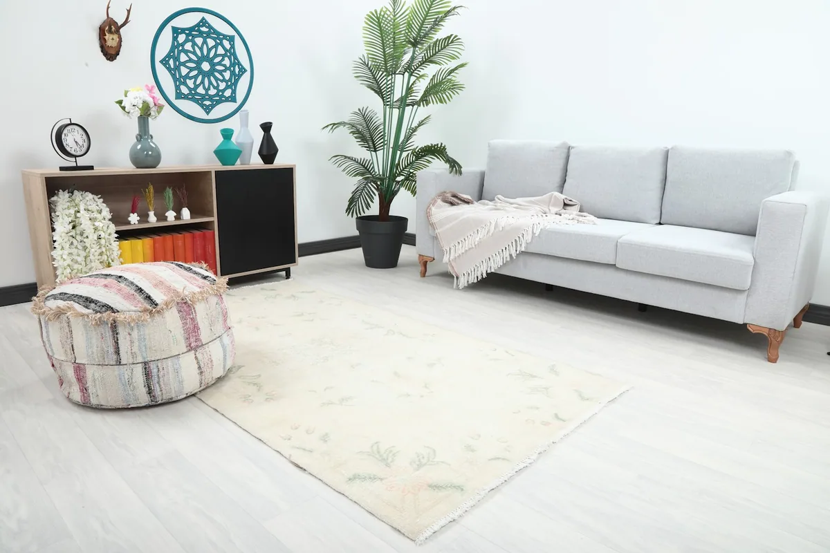 Angle view of the beige floral rug in a contemporary living space with a white wall