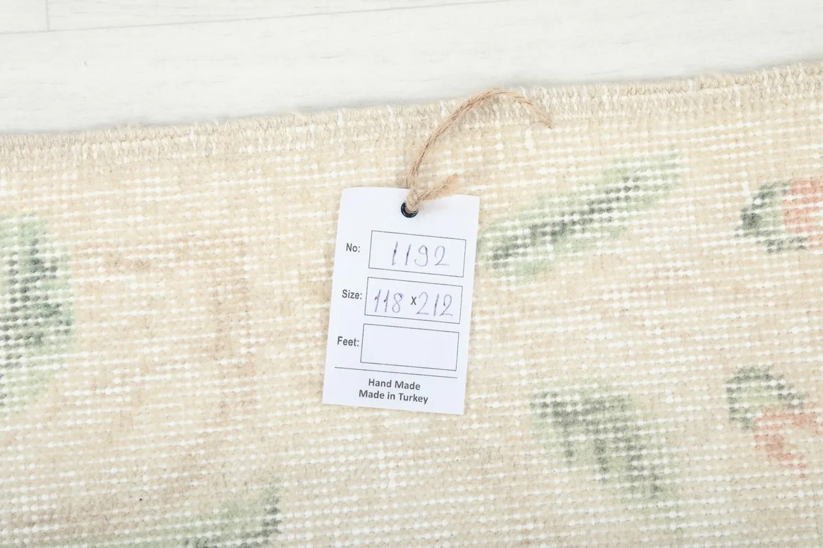Close-up of the rug's texture and a product tag displaying its size and origin