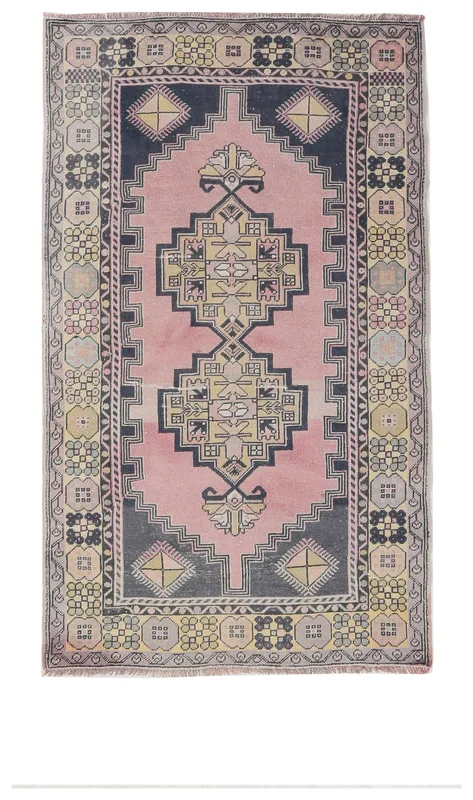 Full overhead view of the 4x6 rose and navy vintage Anatolian rug with geometric medallion on white background