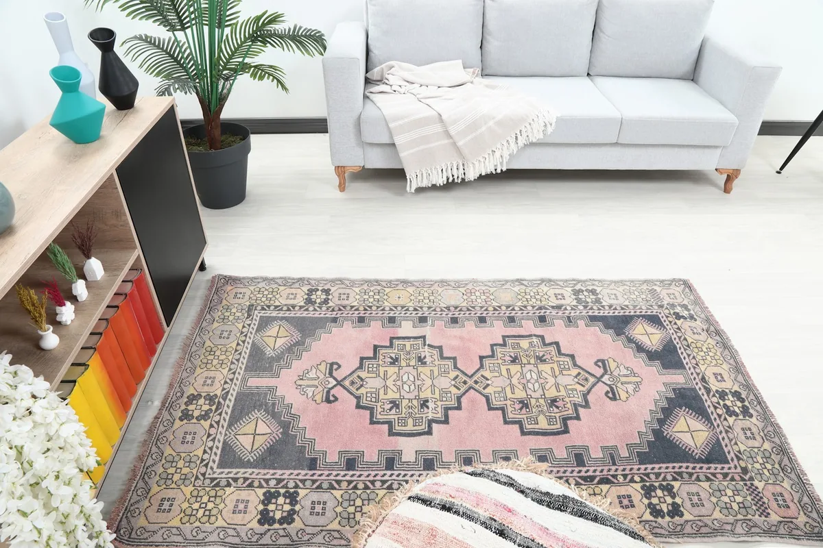 Overhead view of the rug within a room, showing the full design and surrounding light-colored flooring