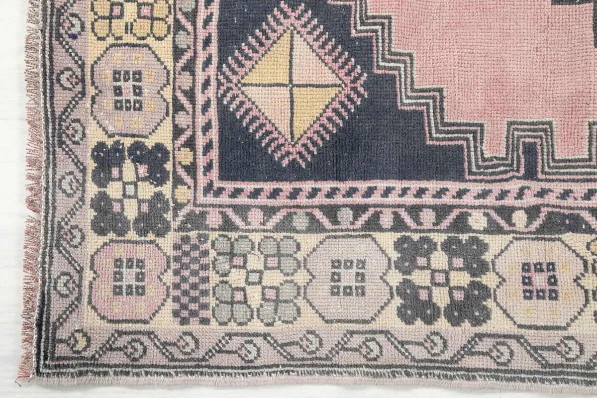 Detailed view of the corner border design, showcasing the varied geometric patterns and color palette