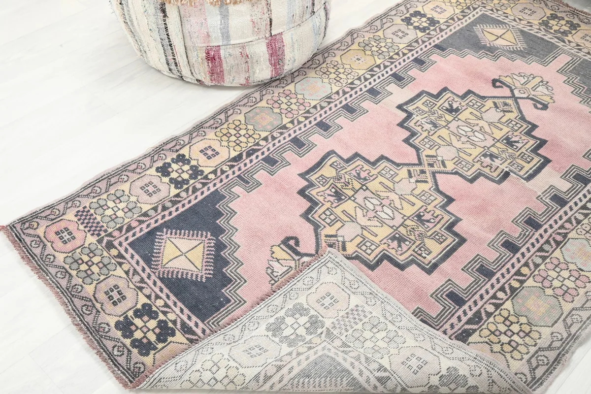 View of the rug's underside and pile from an angle, demonstrating the hand-knotted construction