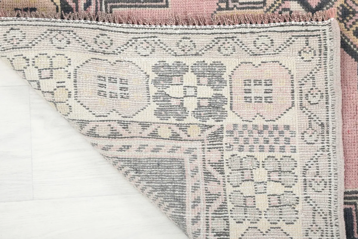 Close-up of the rug's back, revealing the cotton foundation and fine hand-knotting craftsmanship