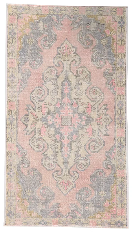 Full top view of the rose and gray Anatolian vintage area rug with a central medallion on a white background.
