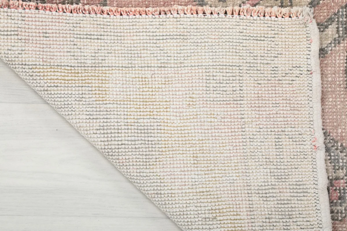 Close-up of the back of the hand-knotted rug, showcasing the cotton foundation and knotting structure.