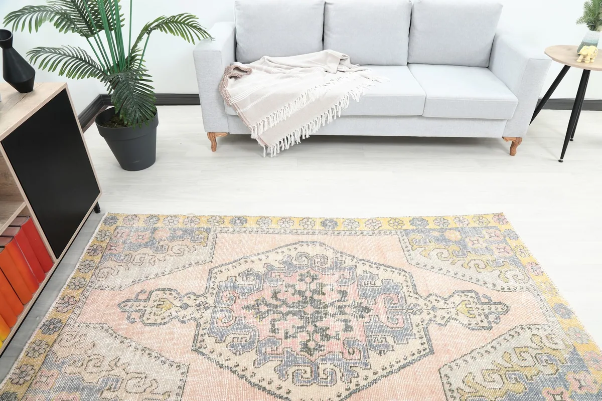 Overhead view of the rug in a room, capturing its colors and patterns in relation to a light gray sofa