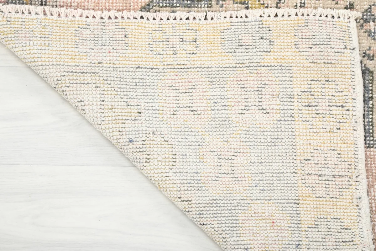 Underside of the rug, showing the hand-knotted cotton foundation and tight weave