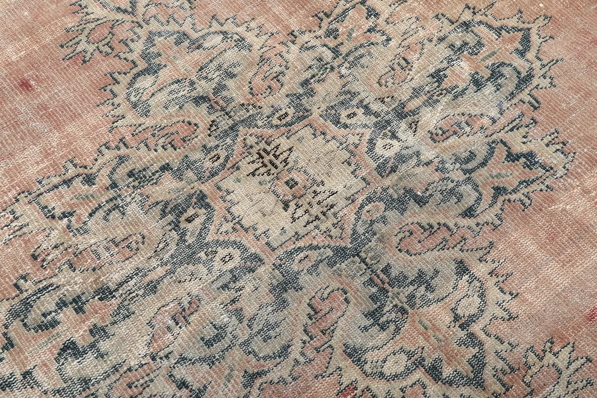 Close-up of the intricate patterns within the navy medallion, revealing individual knots and colors