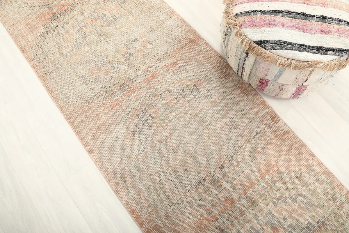 Angled view of the runner rug, showcasing its texture and the subtle color shifts in its design.