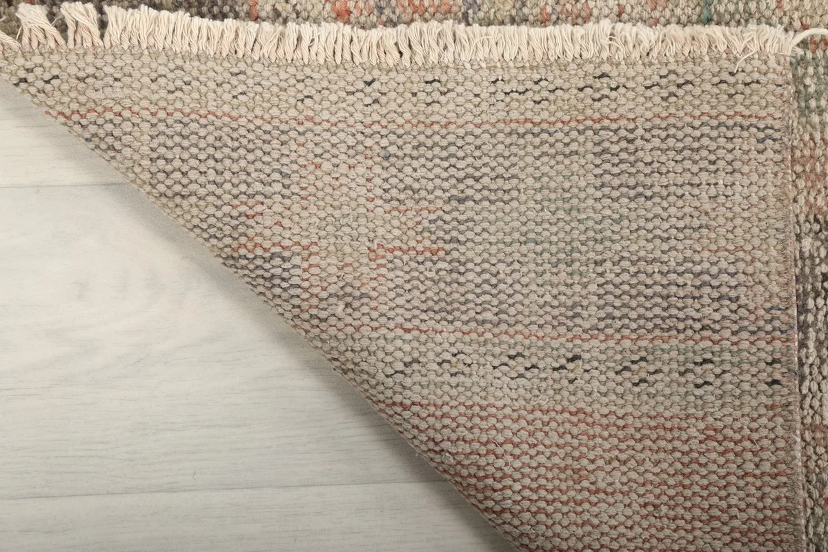 View of the back of the hand-knotted rug, revealing the cotton foundation and knotting.