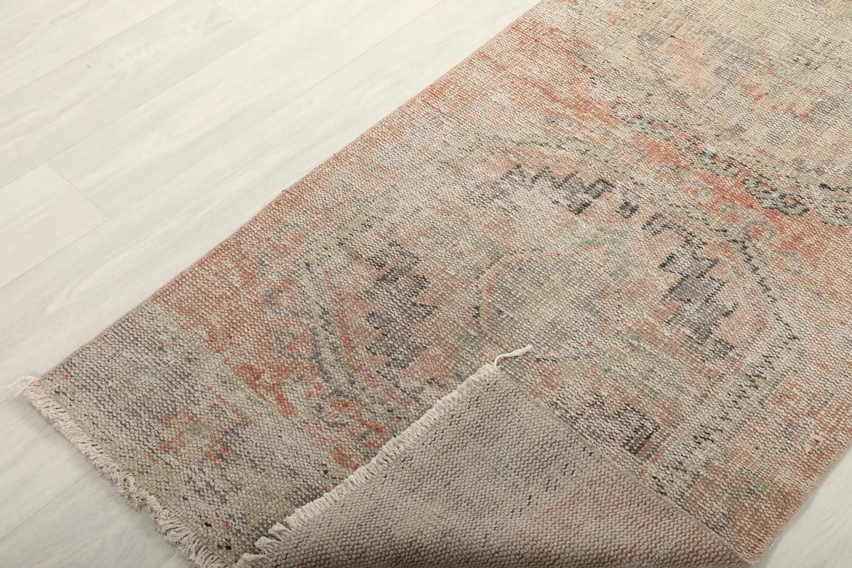 The runner rug folded to show its flexibility and the reverse side of the pile.