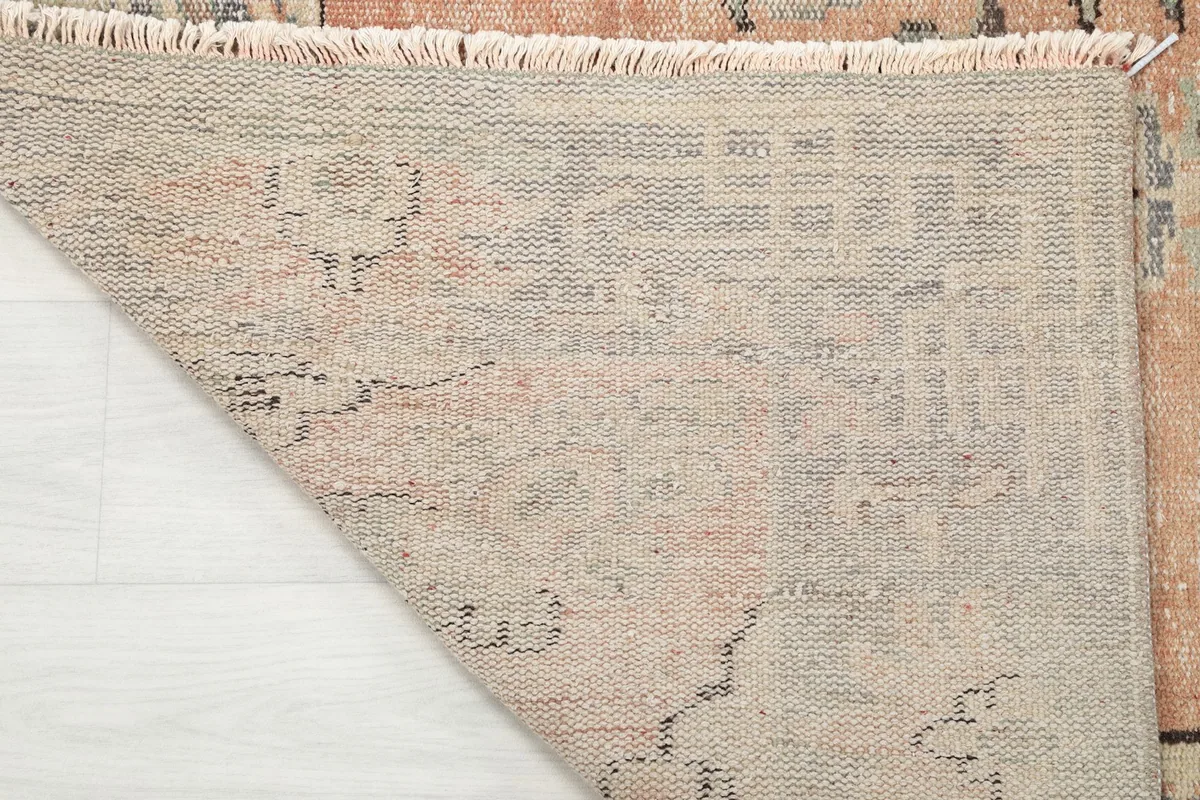Close-up of the rug's underside, showing the hand-knotted cotton foundation and wool knots