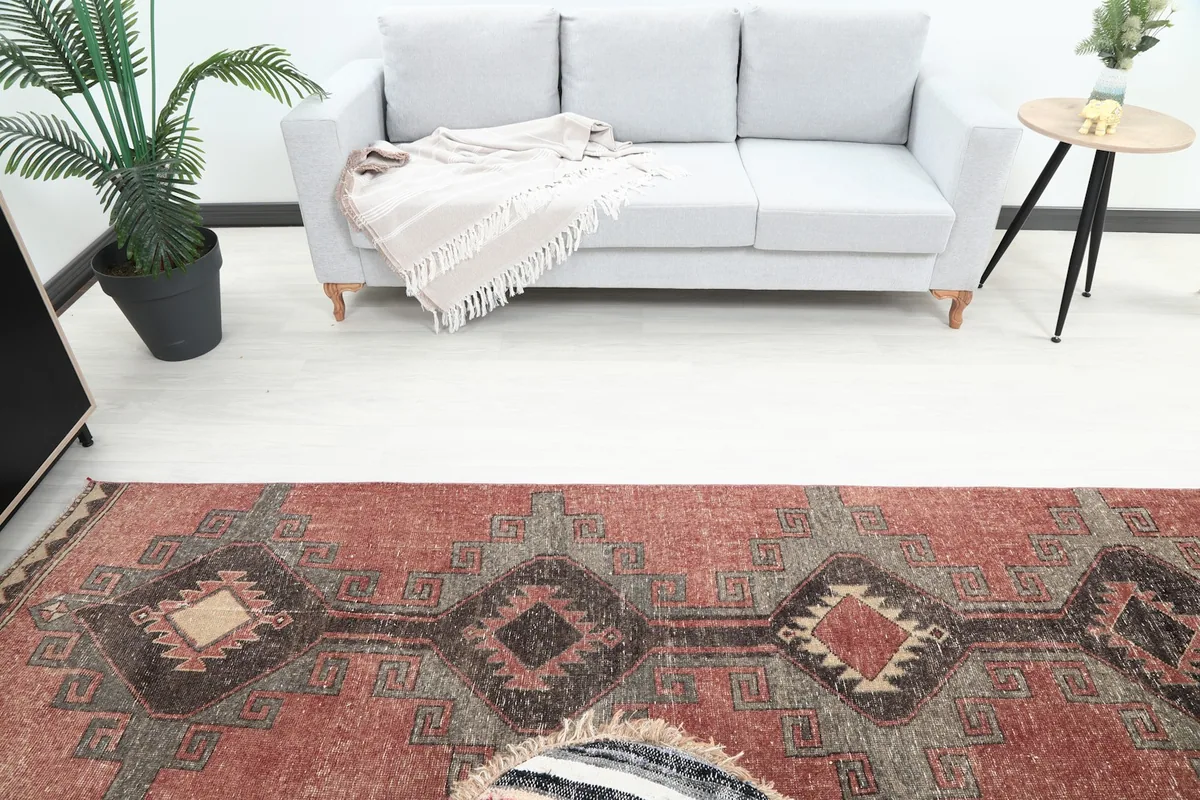 Overhead perspective of the runner rug in a room, highlighting its length and patterns near a sofa.
