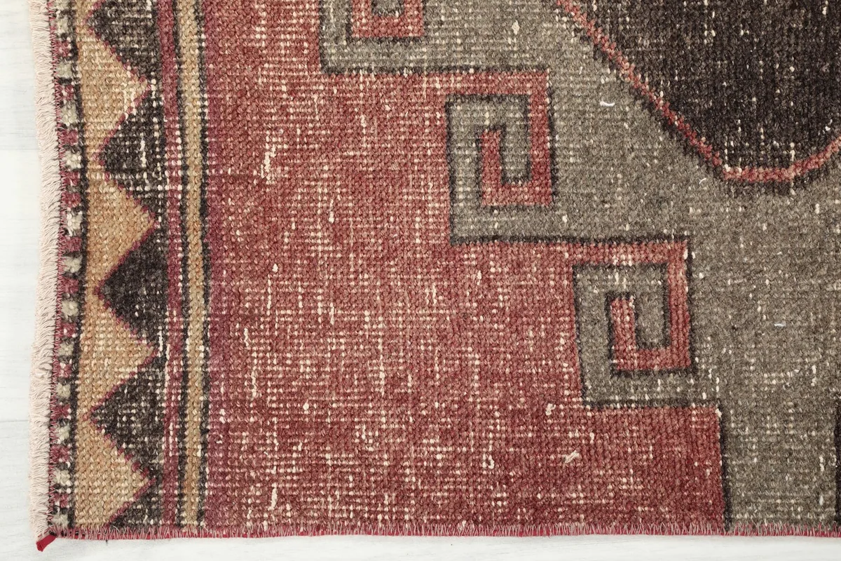 Detailed view of the side border and field of the runner, showing the intricate tribal patterns.