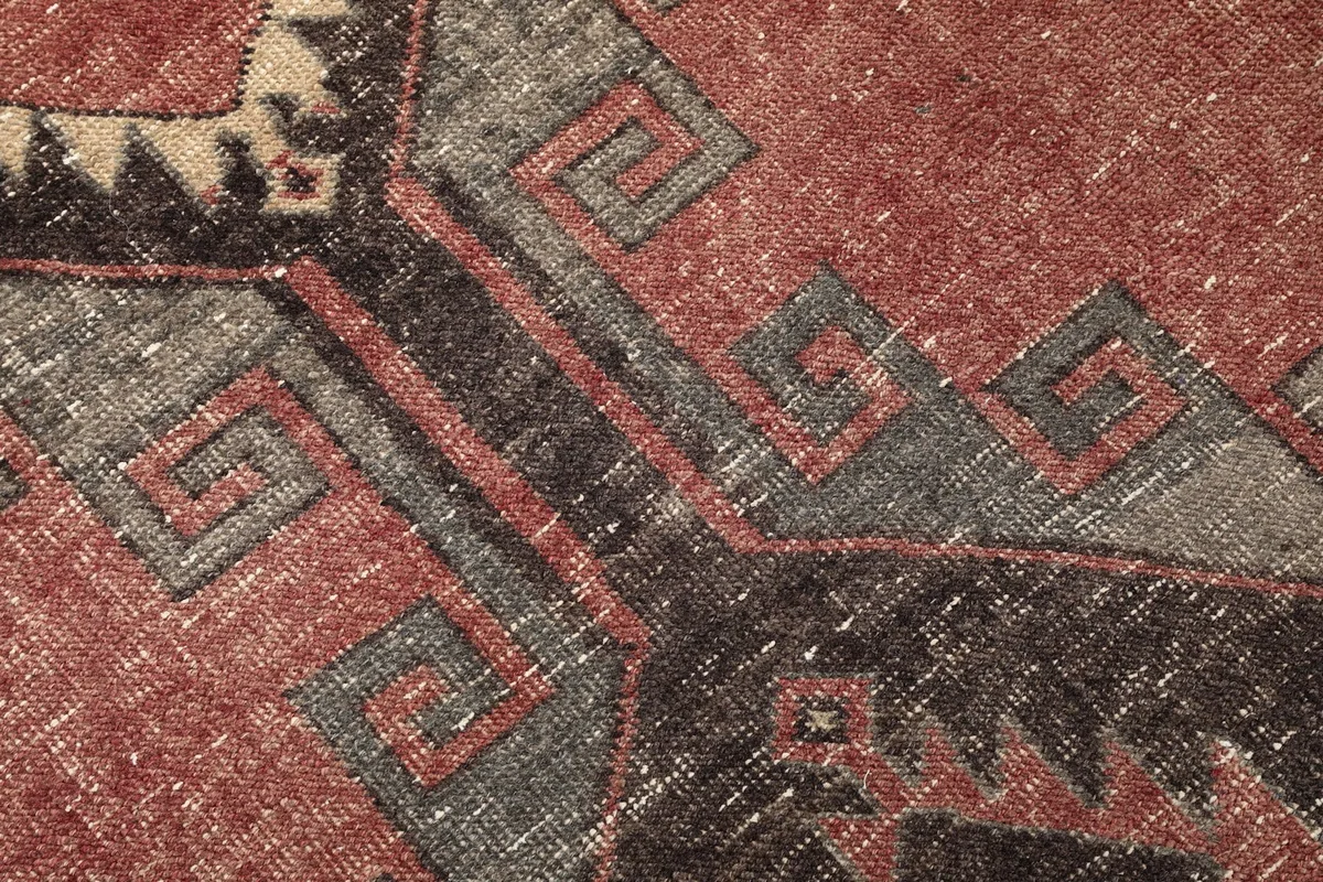 Macro shot of the wool pile, revealing the hand-knotted texture and subtle color blending.