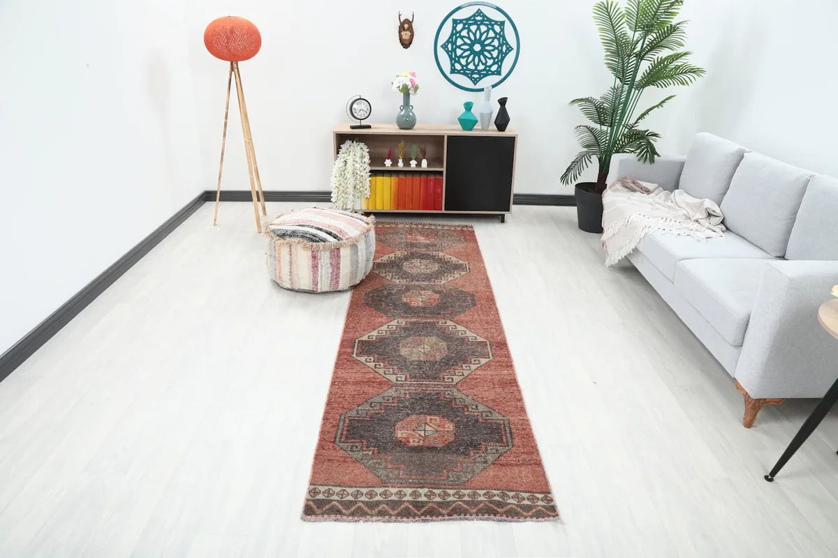 Runner rug in a modern living room setting, showcasing its length and pattern alongside a sofa and decor.