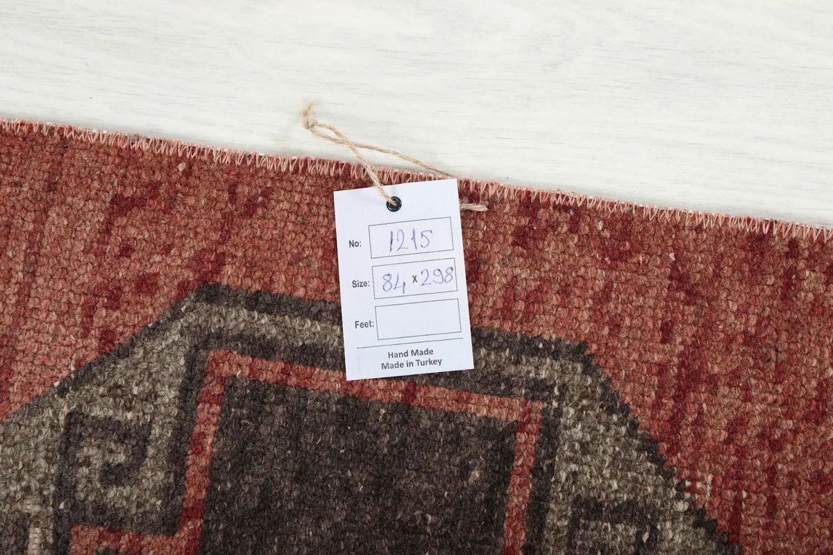 Close-up of the product tag attached to the rug, displaying its size and origin details.