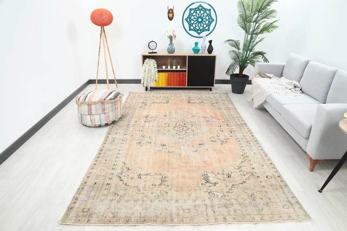 Vintage Anatolian rug in a modern living room setting with a gray sofa and wooden furniture