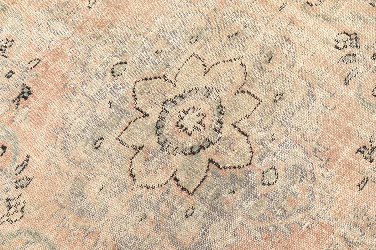 Detailed shot of the central medallion design, highlighting the charcoal and beige tones