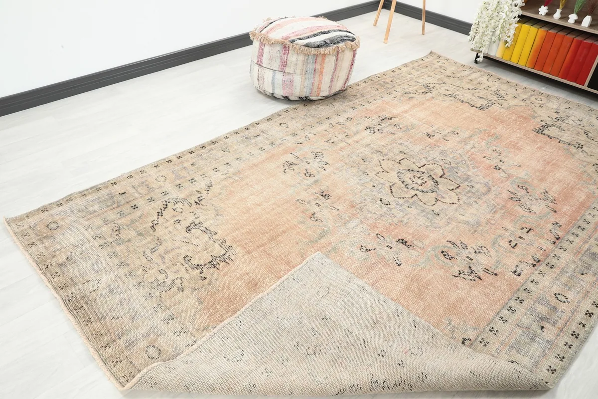 Corner of the rug folded back, showing the cotton foundation and hand-knotted construction