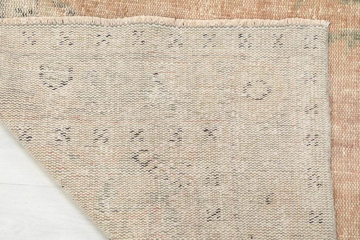 Underside of the rug, revealing the woven cotton foundation and knotting detail
