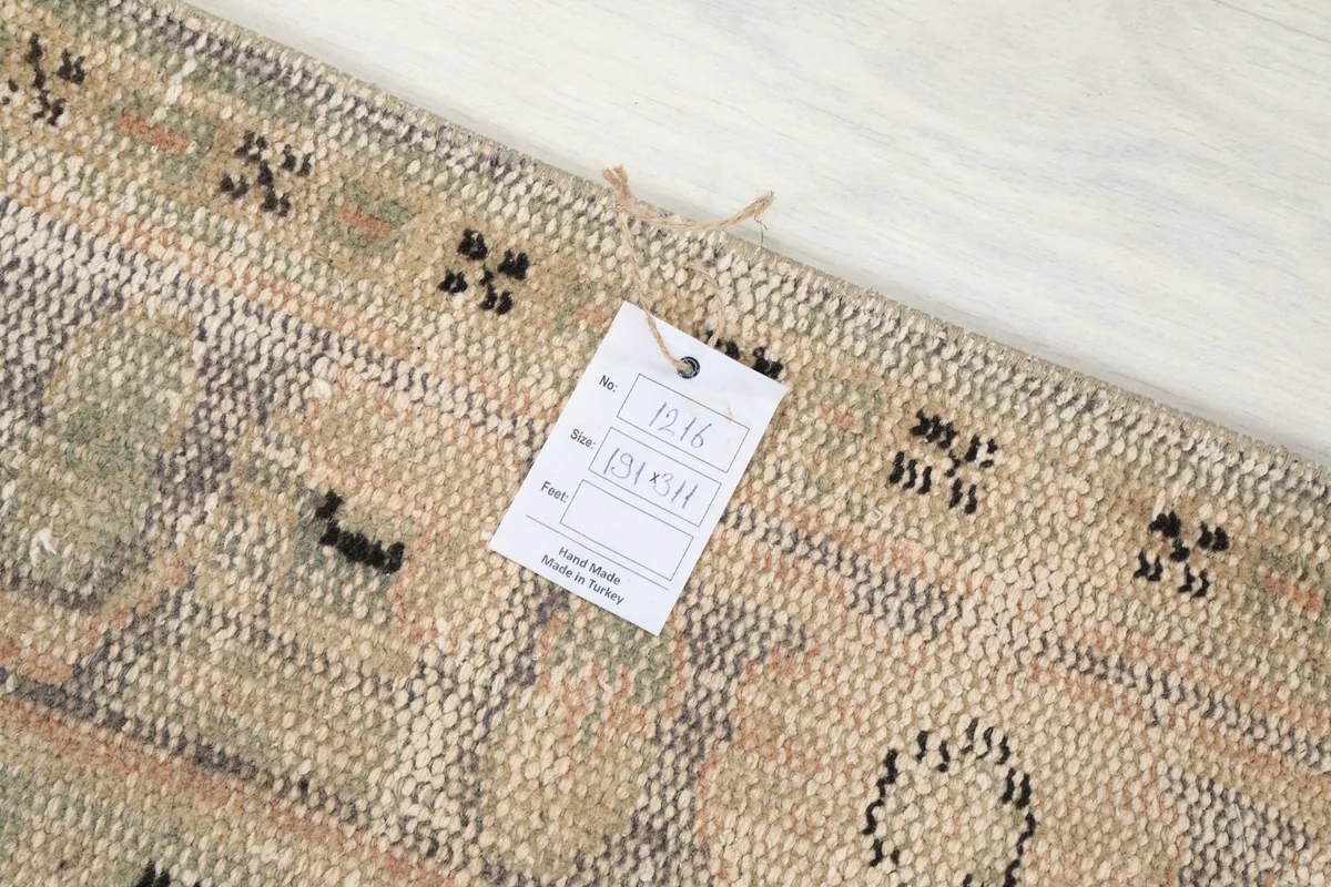 Close-up of the rug's edge with a product tag showing origin and material information