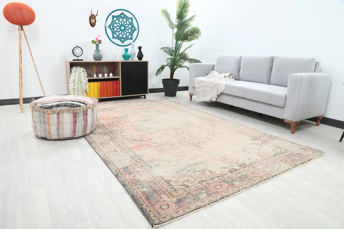Angle view of the ivory and rose rug in a contemporary living space, showing its size