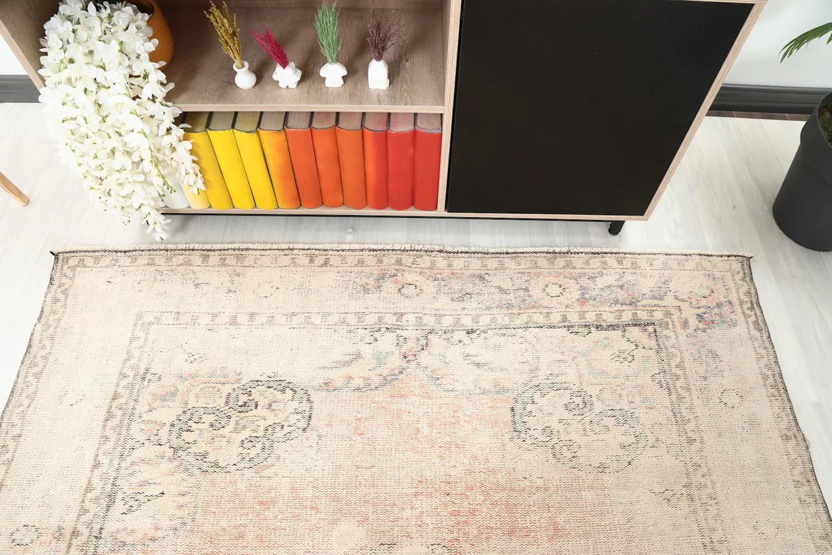 Detailed view of the rug's central design and border from an overhead perspective