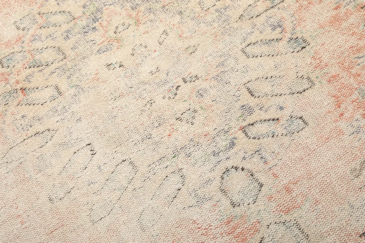 Texture shot of the low wool pile, highlighting the distressed geometric patterns