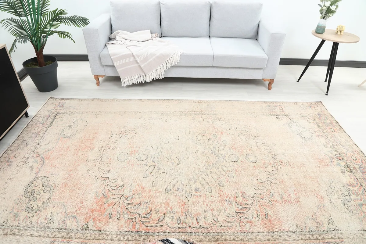 Overhead view of the large vintage rug in a living room, showing its full length