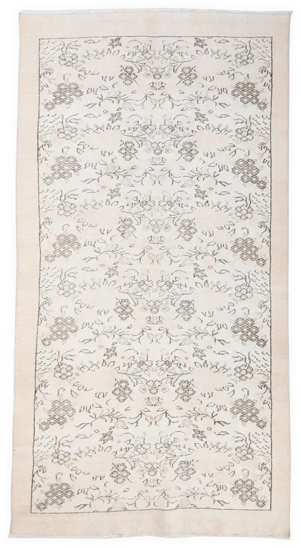 Full overhead view of the 5x9 ivory vintage Anatolian rug with gray floral patterns