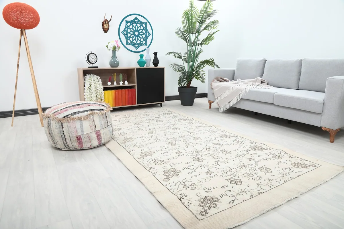 Anatolian ivory rug in a living room, showing its length and floral design