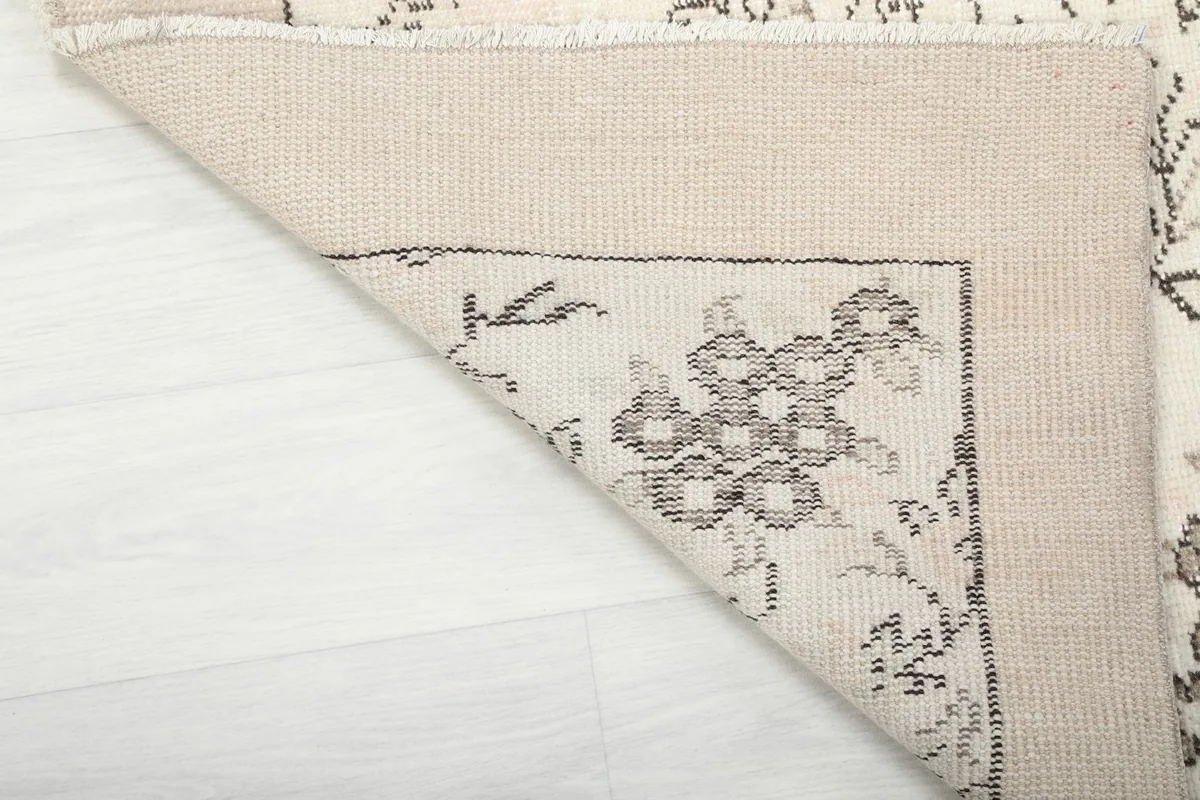 Underside of the hand-knotted rug, revealing the cotton foundation and knotting