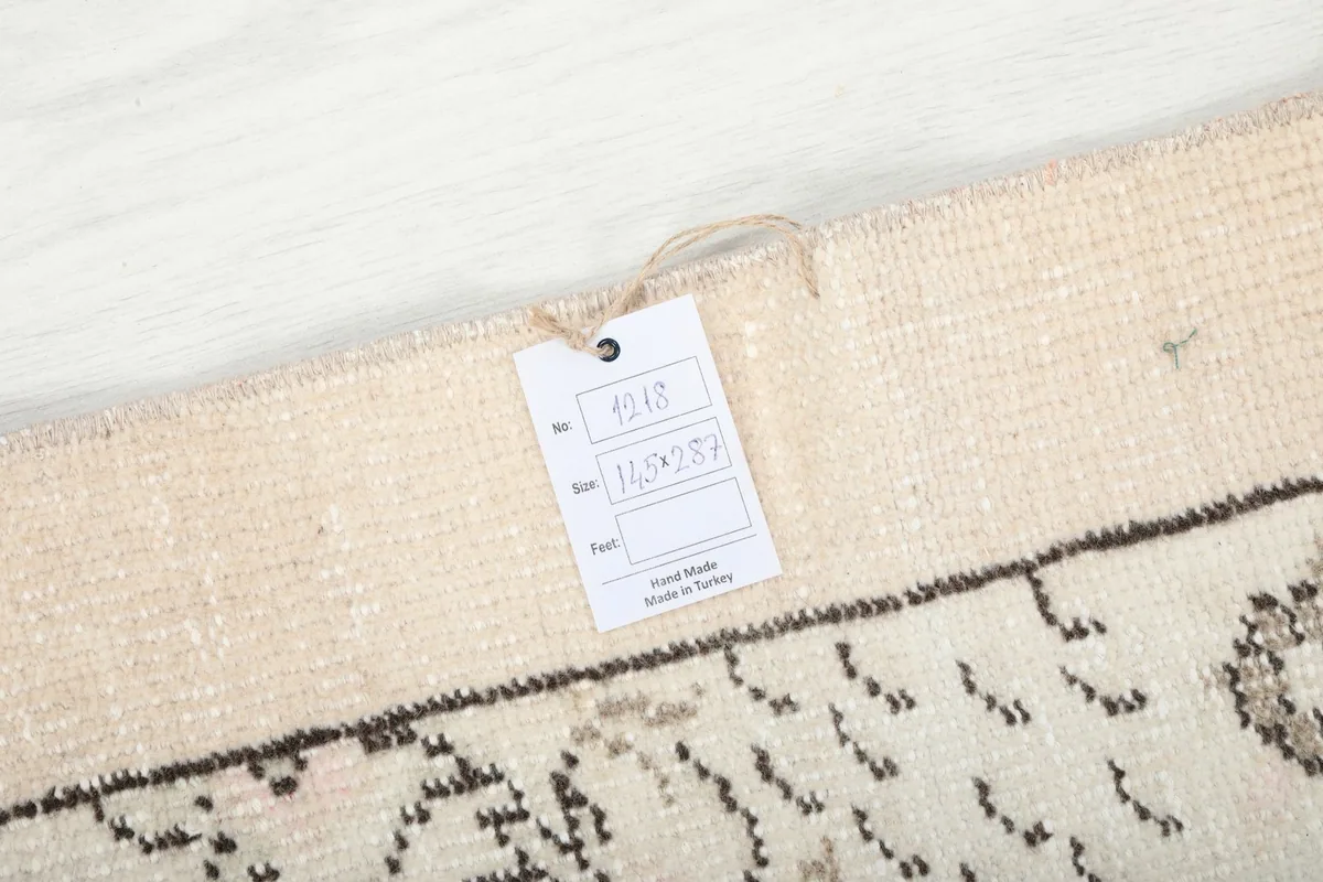 Close-up of the rug's label with size and origin information, attached to the edge