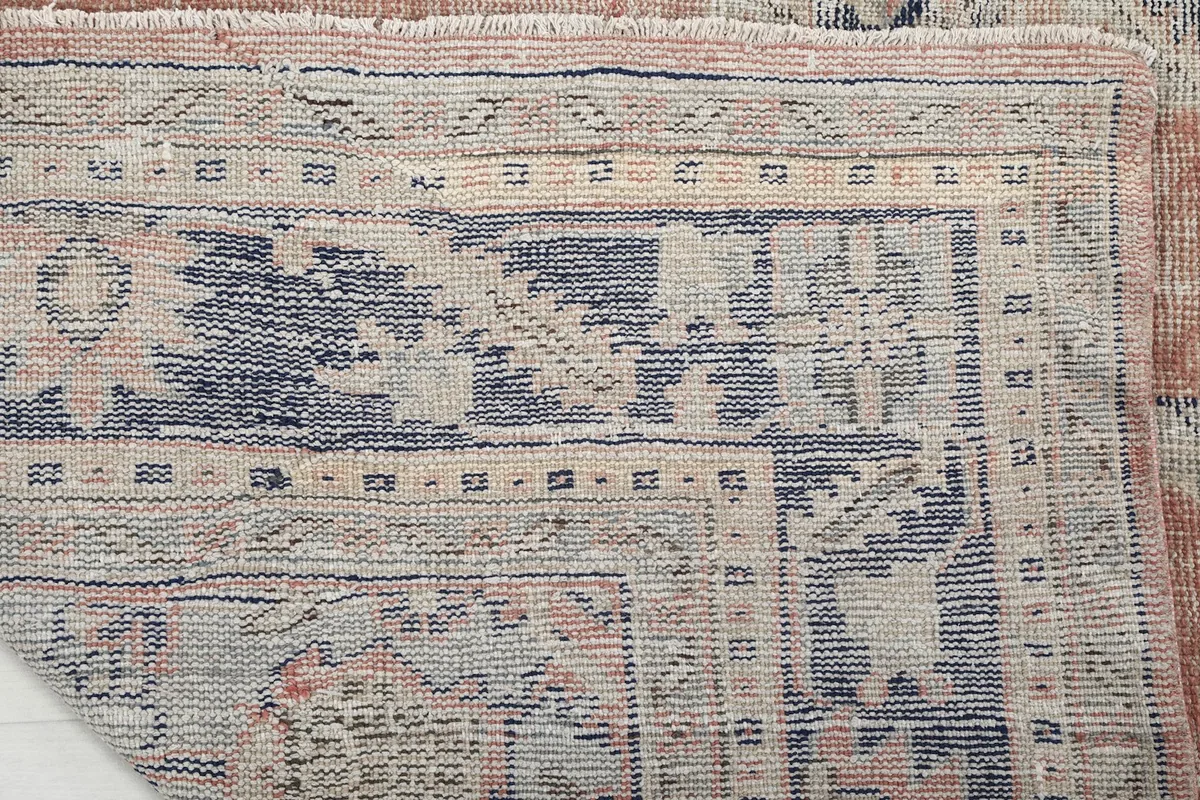 Close-up of the back of the rug, revealing the hand-knotted construction and cotton foundation.