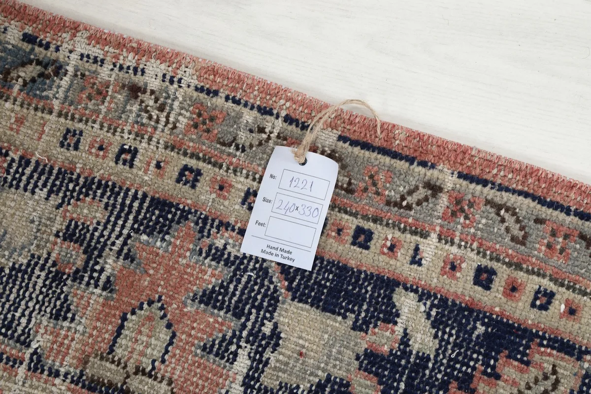 Close-up of the rug's edge with a product tag showing dimensions and origin details.
