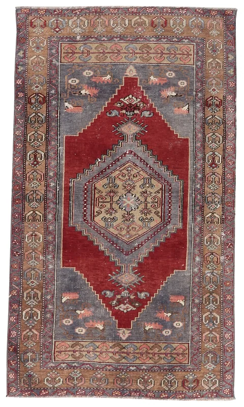 Full top view of the vintage red, gray, and tan Anatolian rug on a white background