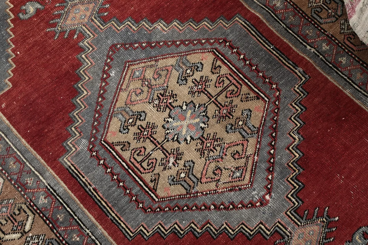 Detailed shot of the hexagonal central medallion with intricate geometric designs in beige and gray