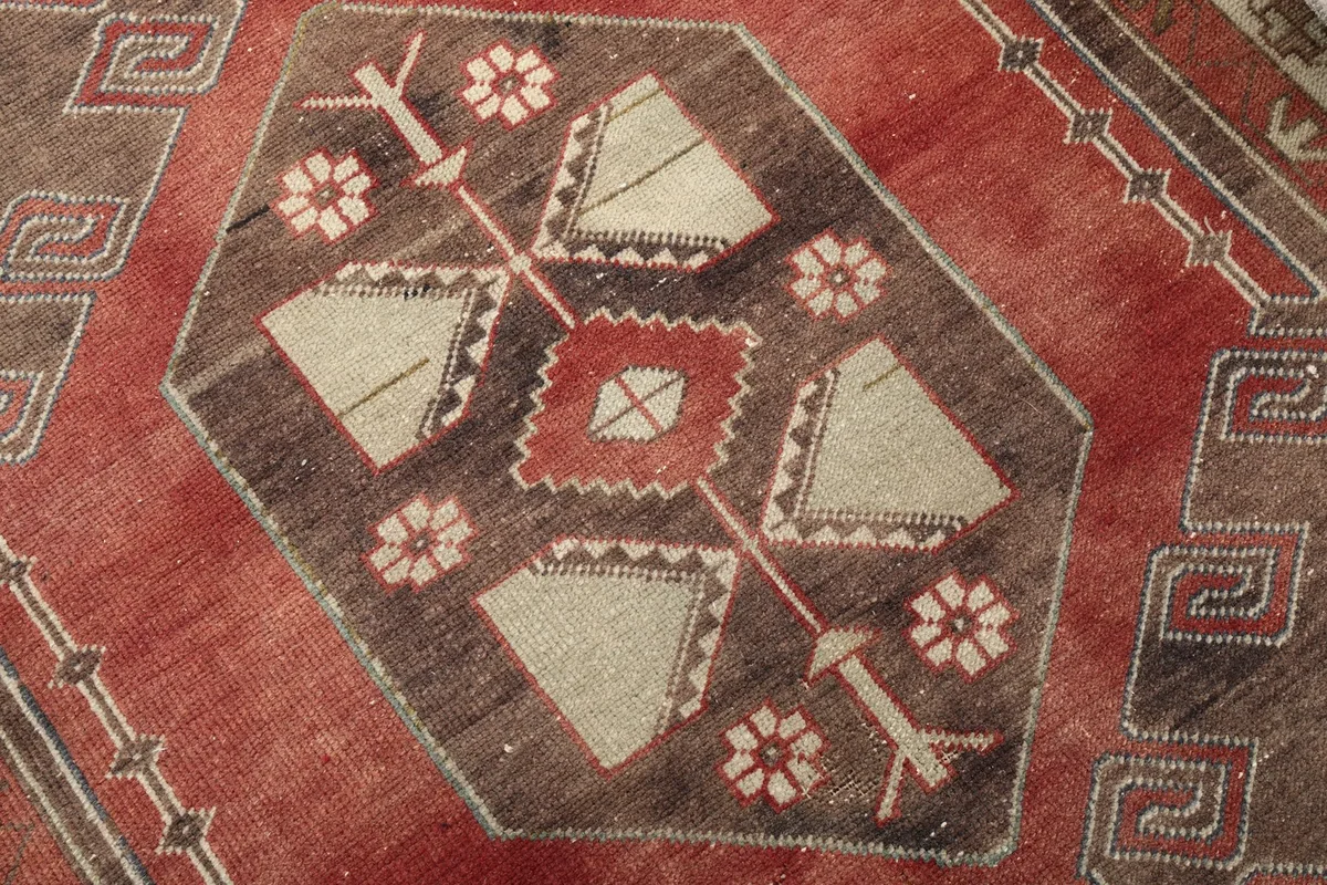 Close-up of a specific tribal motif within the rug, showing the hand-knotted wool texture