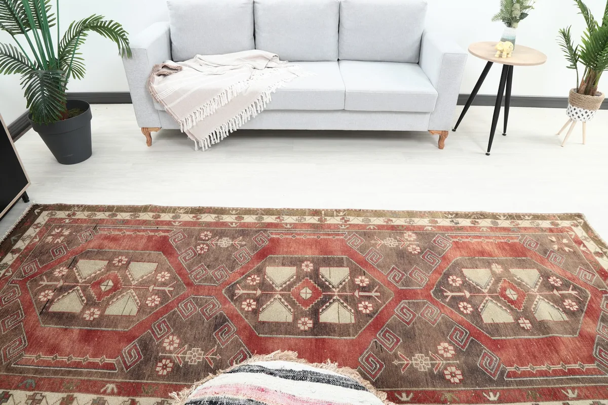 Overhead view of the red and brown runner rug in a room, showing its full design and placement