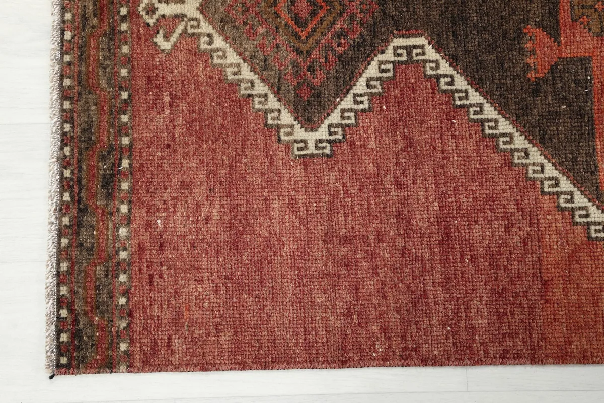 Close-up of the low pile and texture of the hand-knotted wool on cotton foundation.