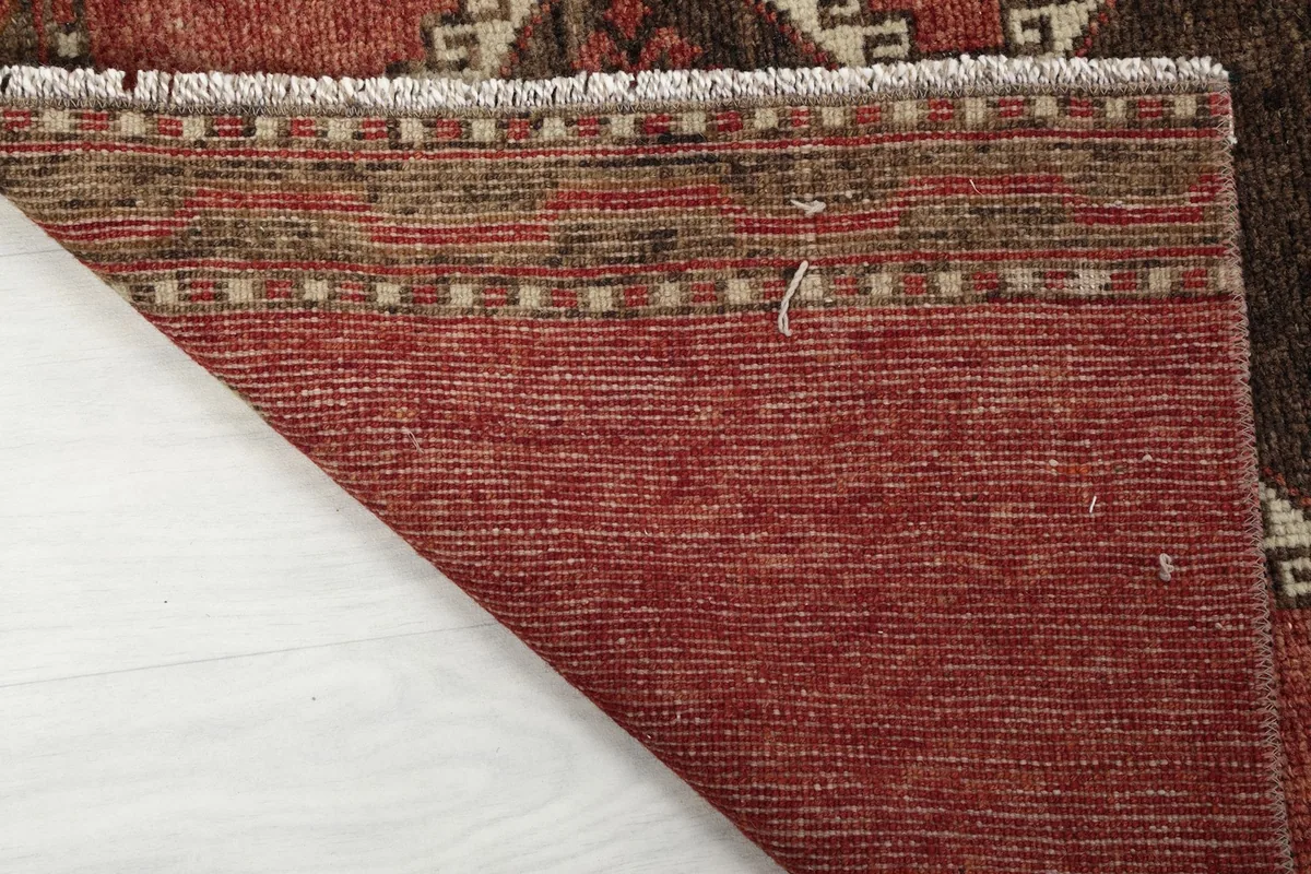 Underside view of the rug, revealing the hand-knotted cotton foundation and weave.