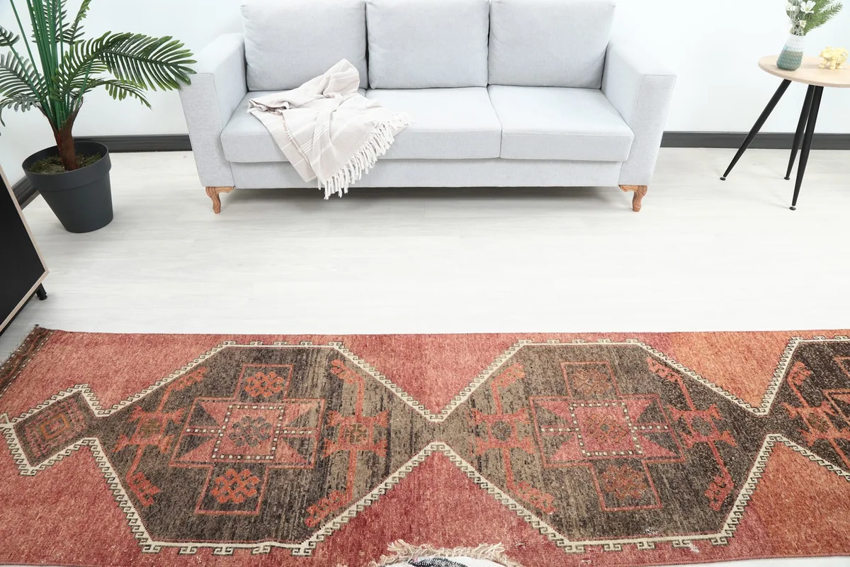 Overhead view of the runner rug in a room, displaying its central geometric design and colors.