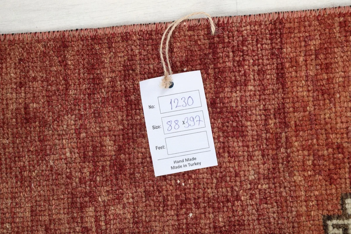 Close-up of the product tag indicating 'Hand Made in Turkey' and rug dimensions.