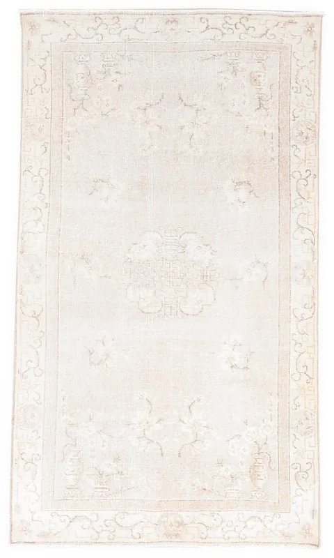 Full overhead view of the beige Anatolian vintage wool rug with a central medallion on a white background.