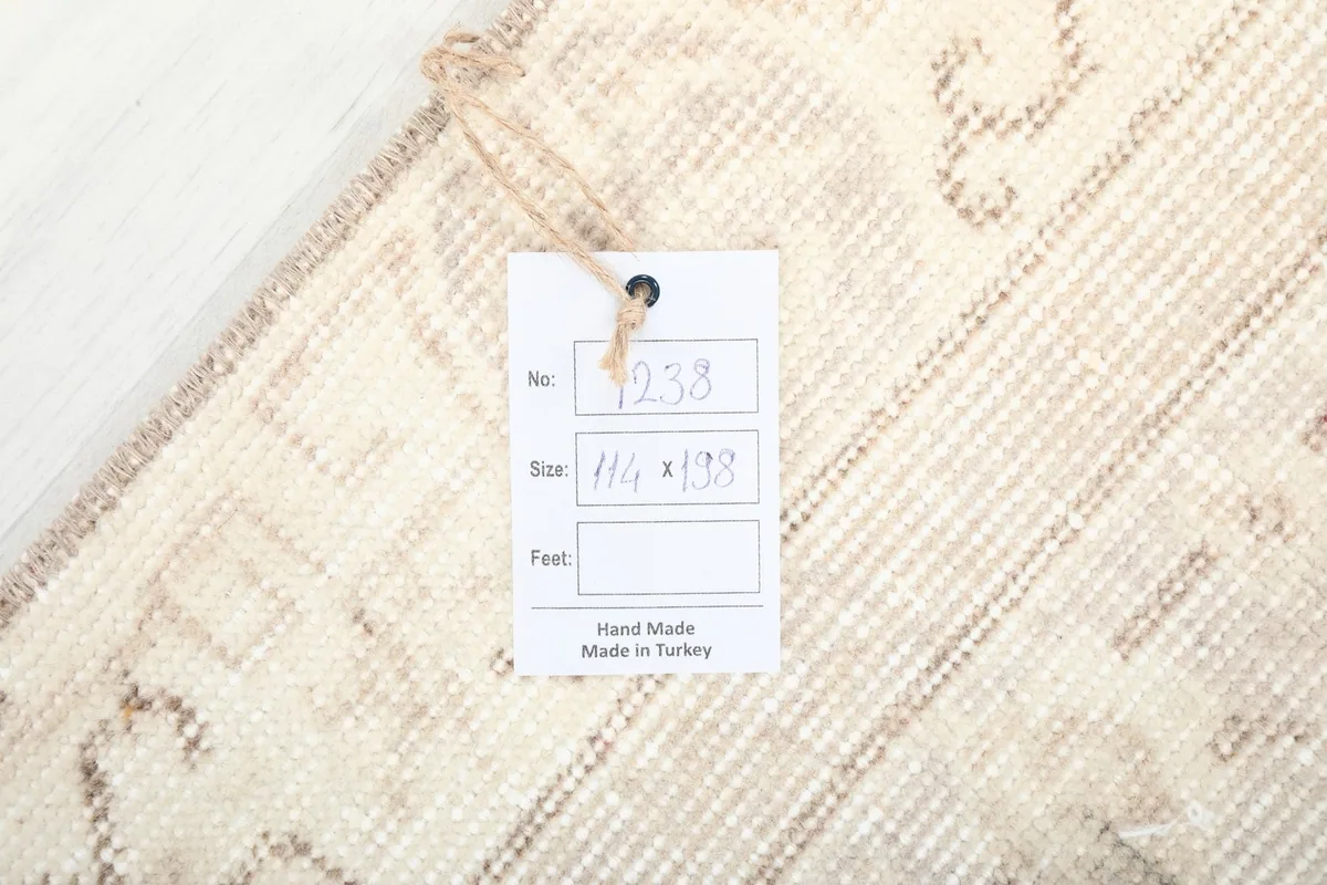 Tag displaying the rug's item number and size (114 x 198 cm), confirming it is hand made in Turkey.