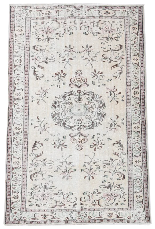 Full top view of the 4'8" x 7'6" vintage Anatolian rug with ivory field and brown medallion.